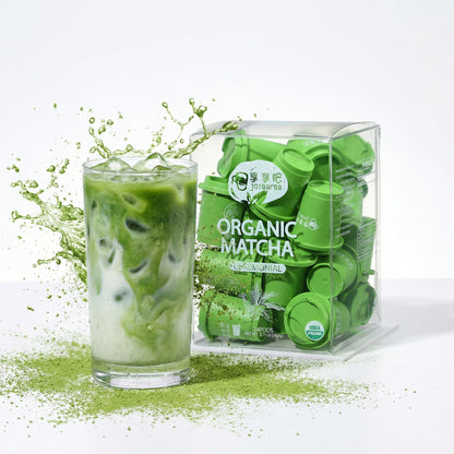 Glass of green matcha drink with a package of Organic Matcha on a white background